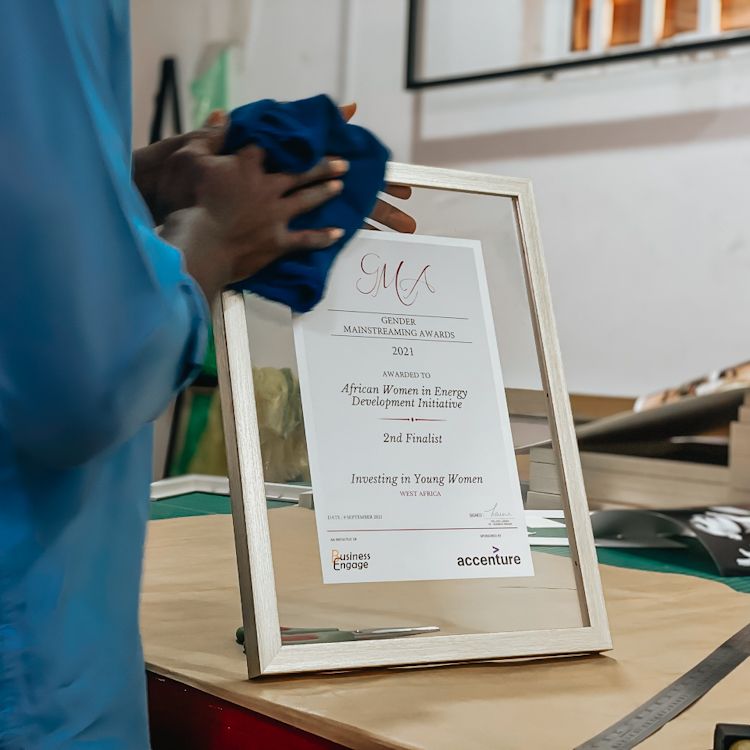 Person holding an award in a double glass frame