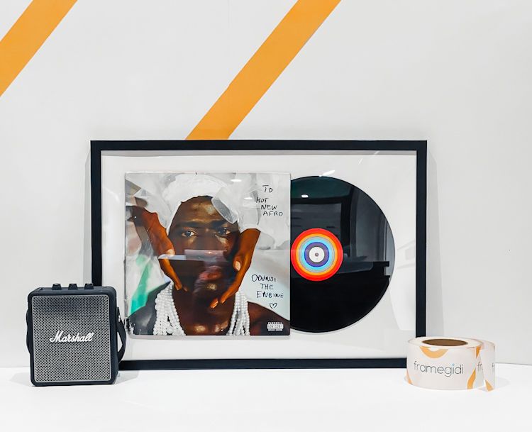 Vinyl record and album cover in a plexiglass frame