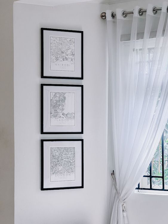 Gallery wall featuring maps of Nairobi, Lagos and London