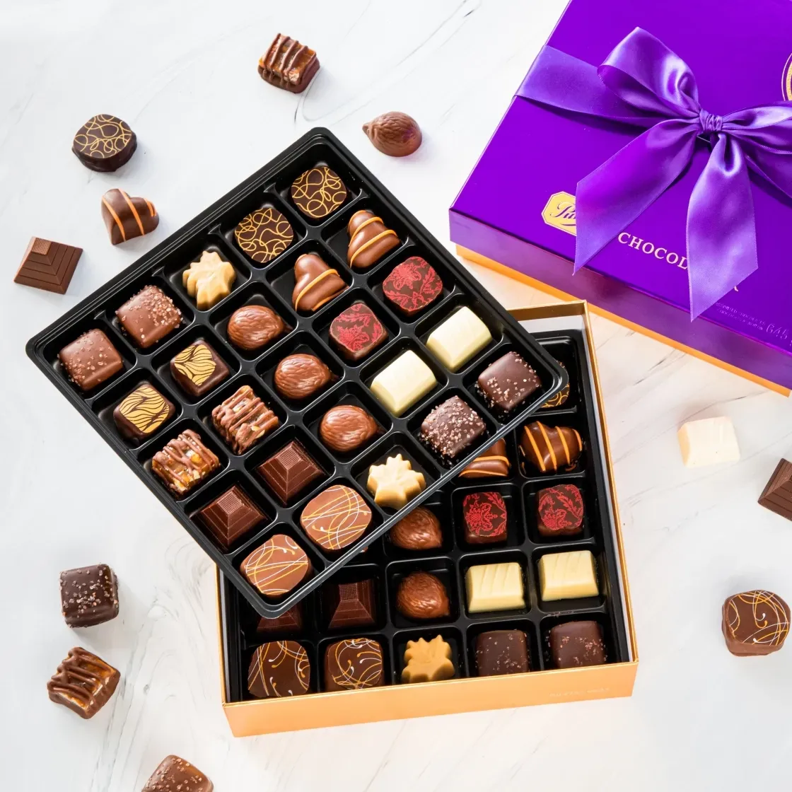 Two boxes of chocolate in various textures and flavours