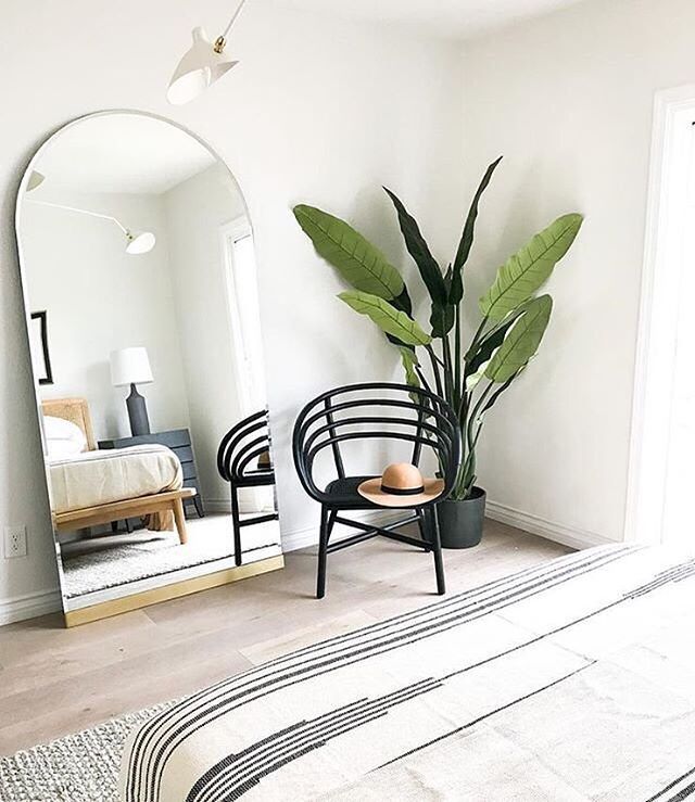 Photo of a bedroom with a large mirror